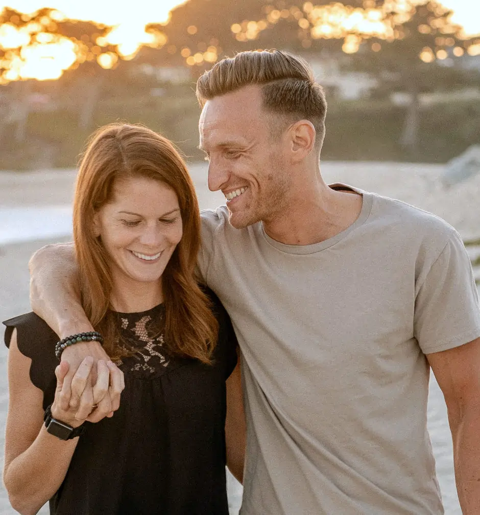 couple walking on beach -credit allen-taylor